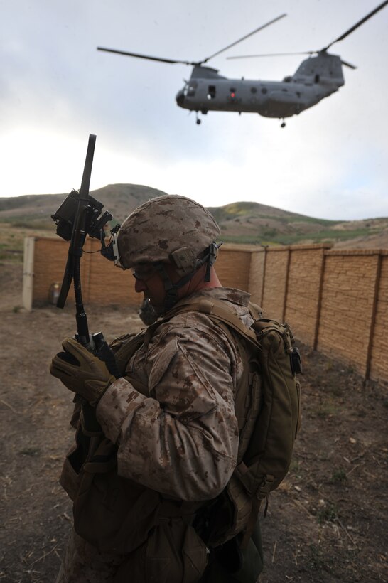 Gunnery Sgt. Jason D. Walker calls in a notional casualty evacuation request during a raid course here June 16. Walker is with India Company, Battalion Landing Team 3/1, the ground combat element for the 11th Marine Expeditionary Unit.